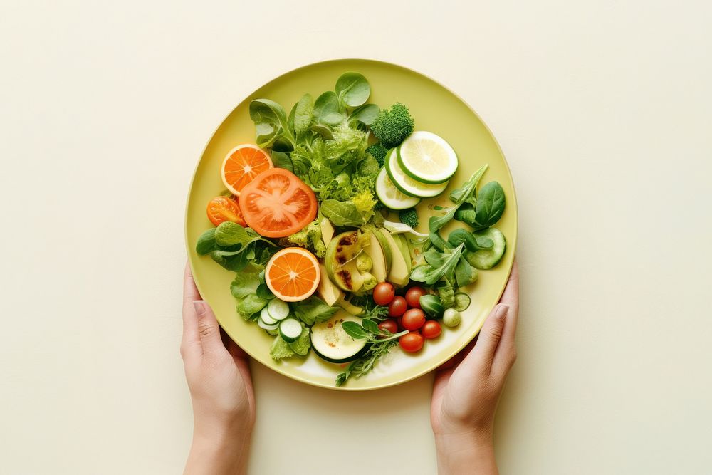 Hands holding salad vegetable on plate food meal dish. AI generated Image by rawpixel.