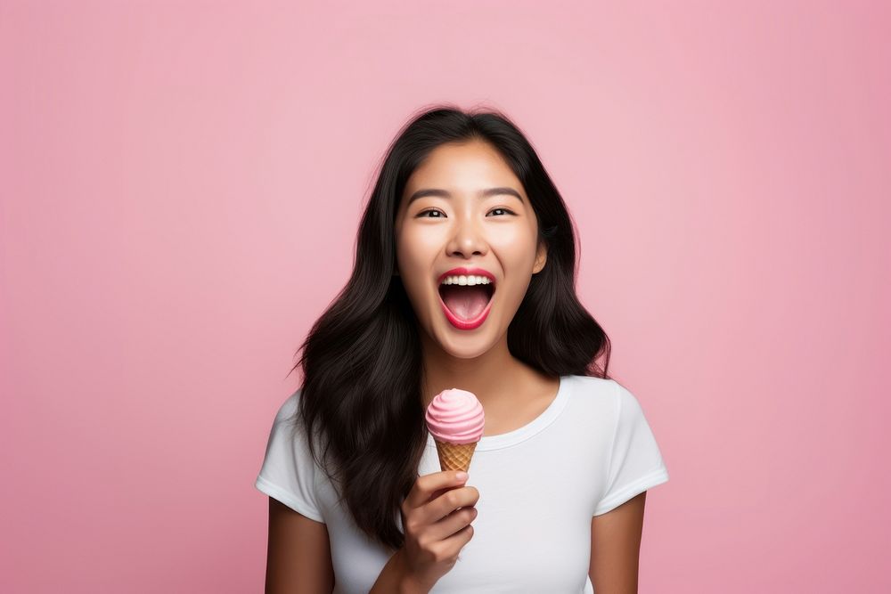Asian woman licks delicious ice cream surprised adult happiness. AI generated Image by rawpixel.