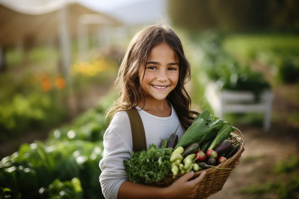 A happy female farmer holding vegetables gardening outdoors organic. 