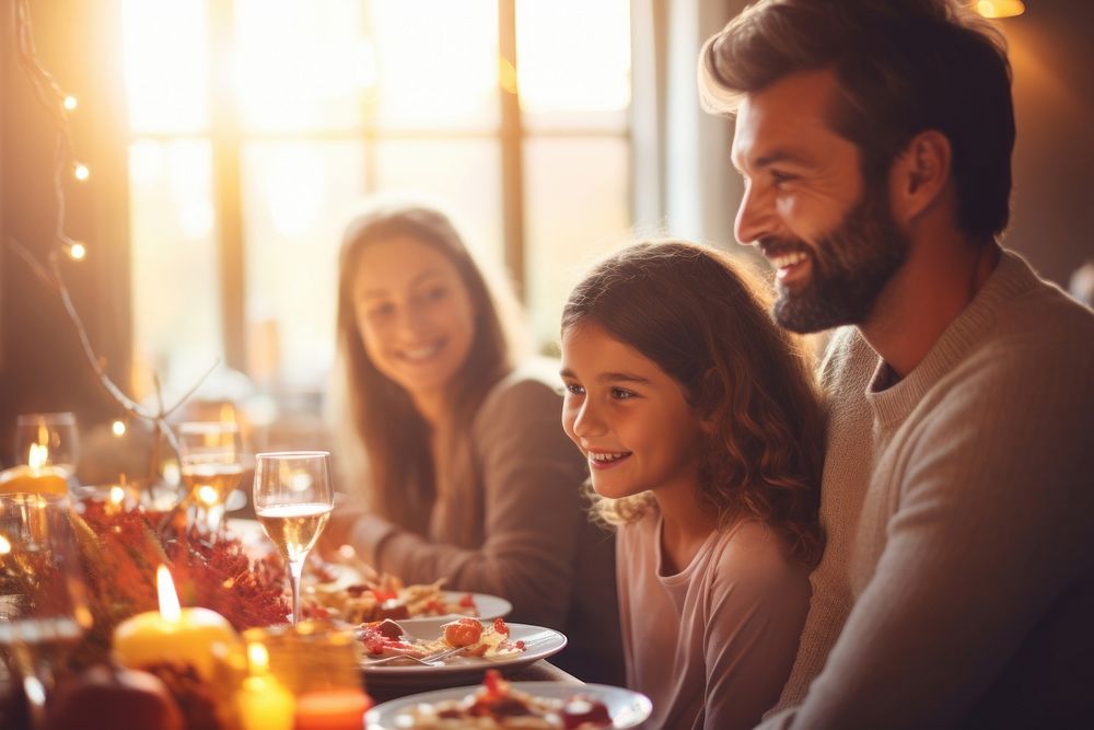 Happy family sitting at the table and celebrating holiday thanksgiving candle dinner. AI generated Image by rawpixel.