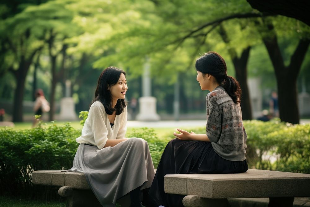 Asian woman park conversation outdoors. AI generated Image by rawpixel.
