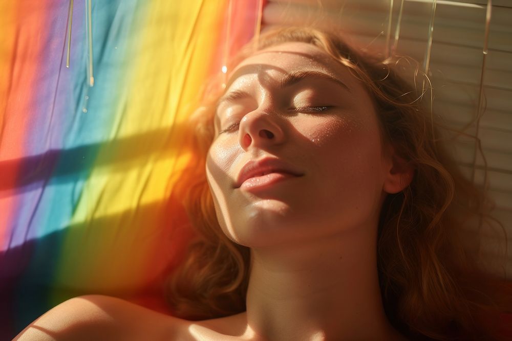 Rainbow ray lay down on woman face portrait photo sun. AI generated Image by rawpixel.