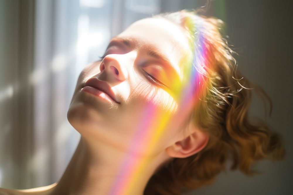 Rainbow ray lay down on woman face portrait adult photo. AI generated Image by rawpixel.