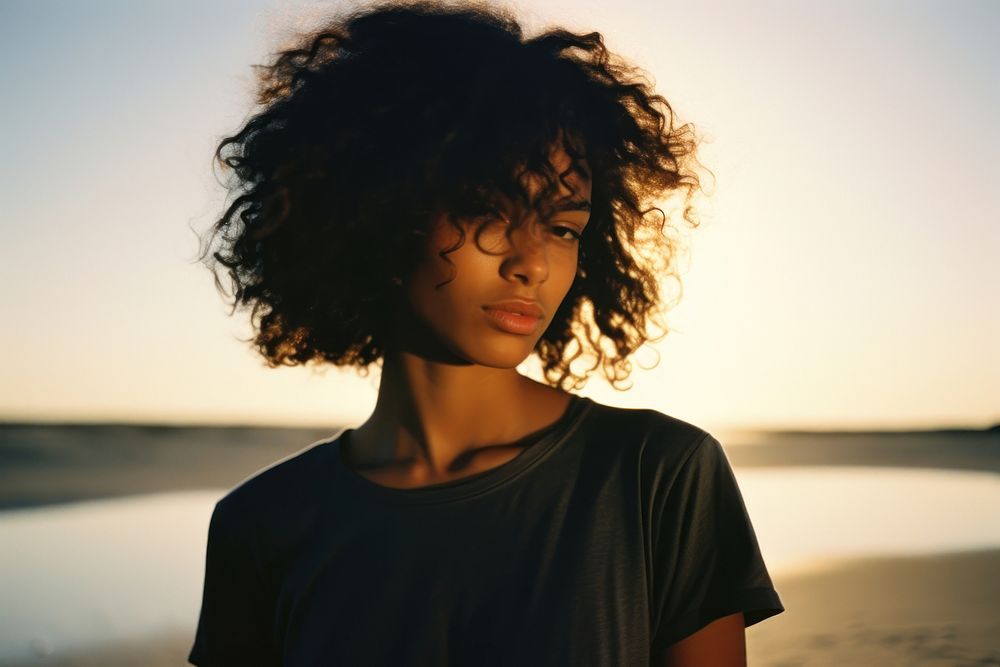 A cool black teenage girl at the beach photography portrait adult. AI generated Image by rawpixel.