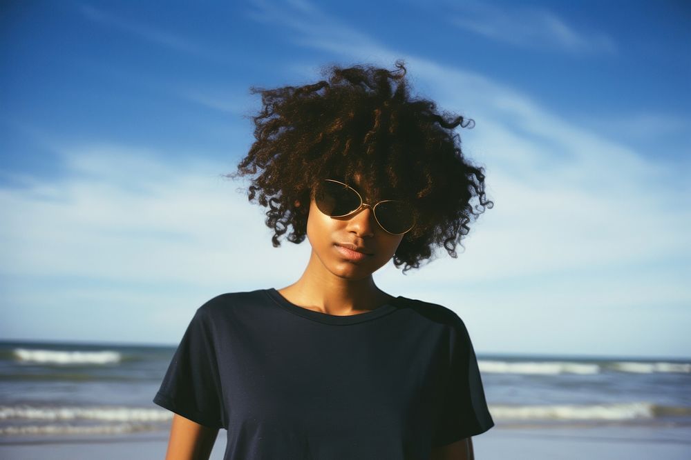 A cool black teenage girl at the beach photography glasses accessories. AI generated Image by rawpixel.