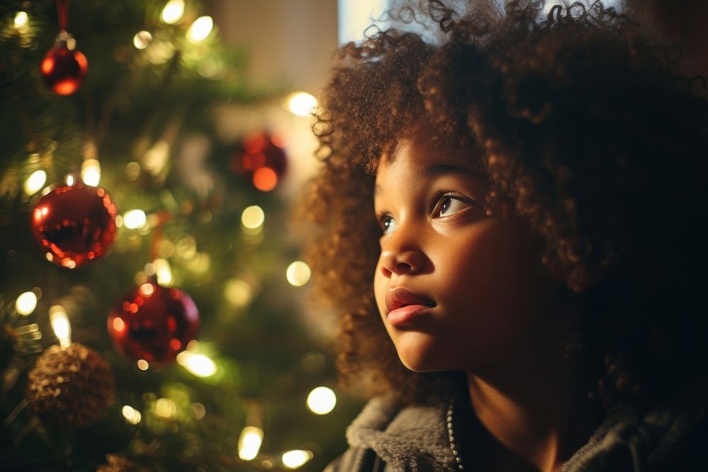 A black girl looking at the christmas tree photography portrait contemplation. AI generated Image by rawpixel.