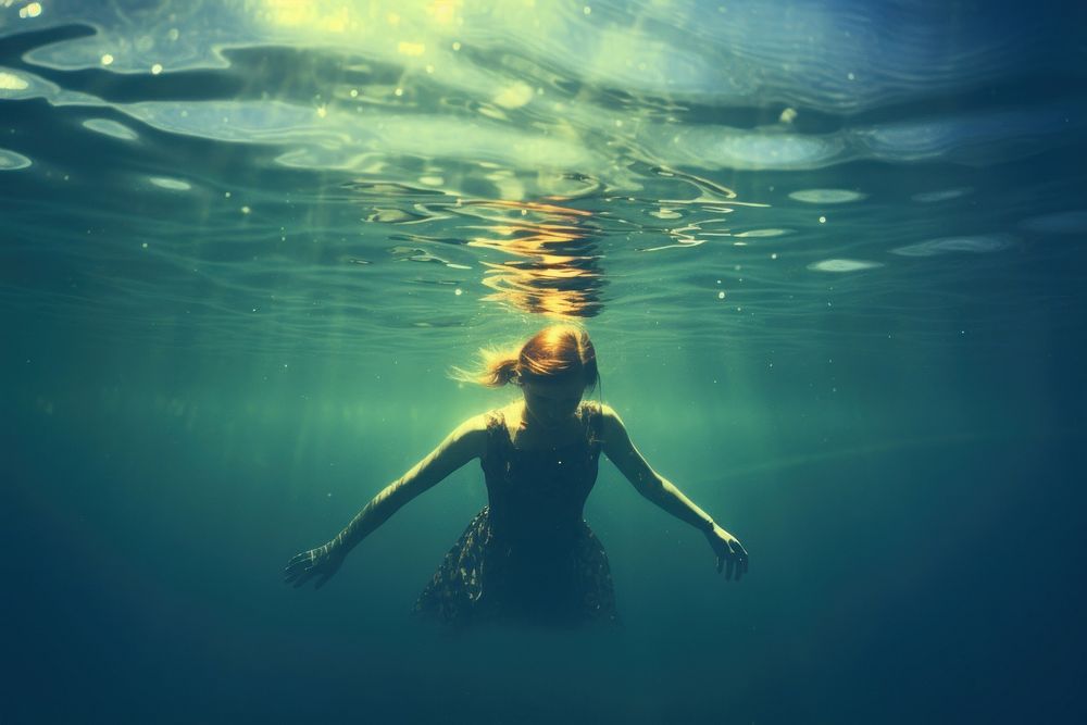 A woman swimming in the sea underwater outdoors nature. AI generated Image by rawpixel.