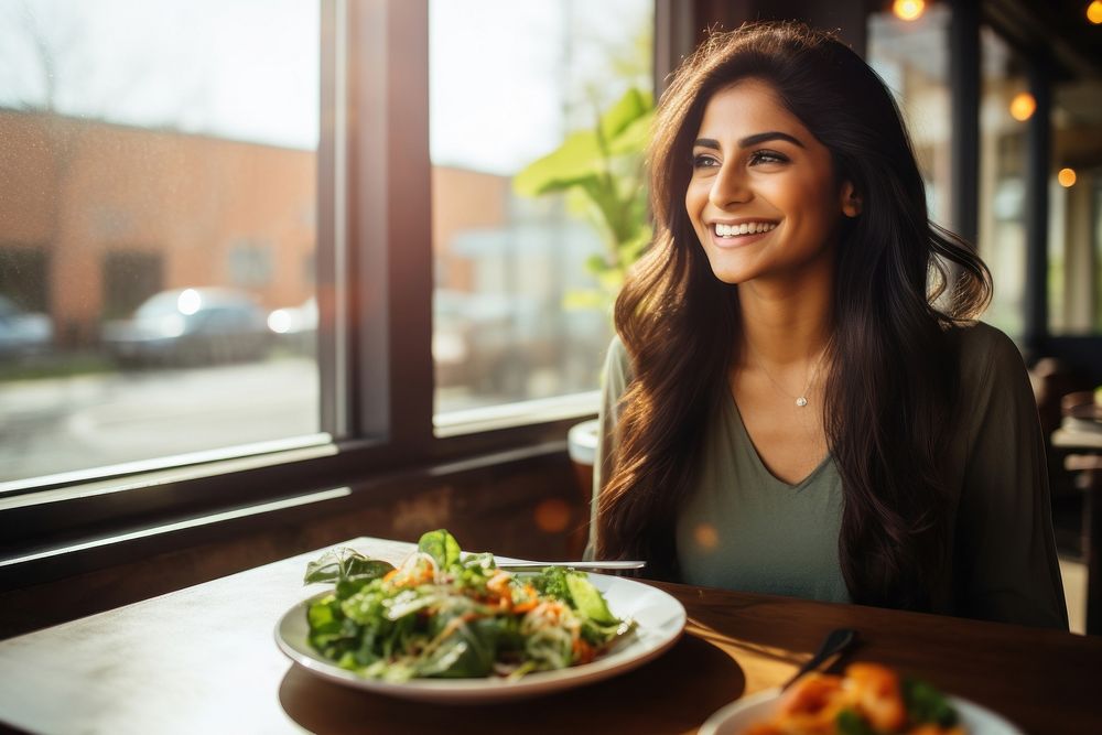 South Asian woman restaurant eating smile. AI generated Image by rawpixel.