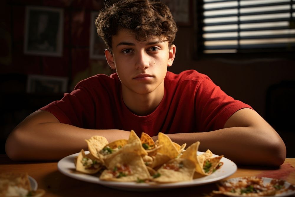 Mexican teenage boy food nachos plate. AI generated Image by rawpixel.