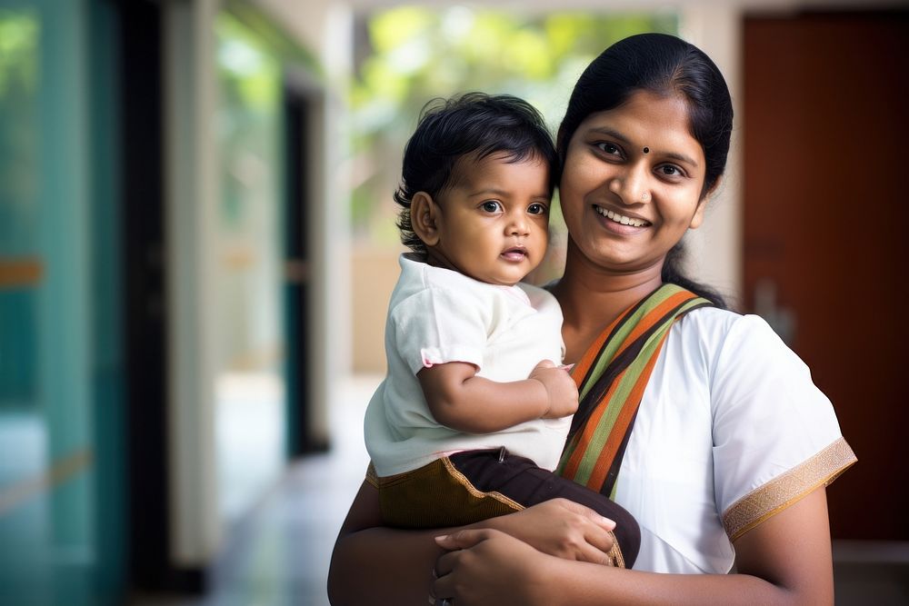 Indian woman doctor smiling adult holding family. AI generated Image by rawpixel.