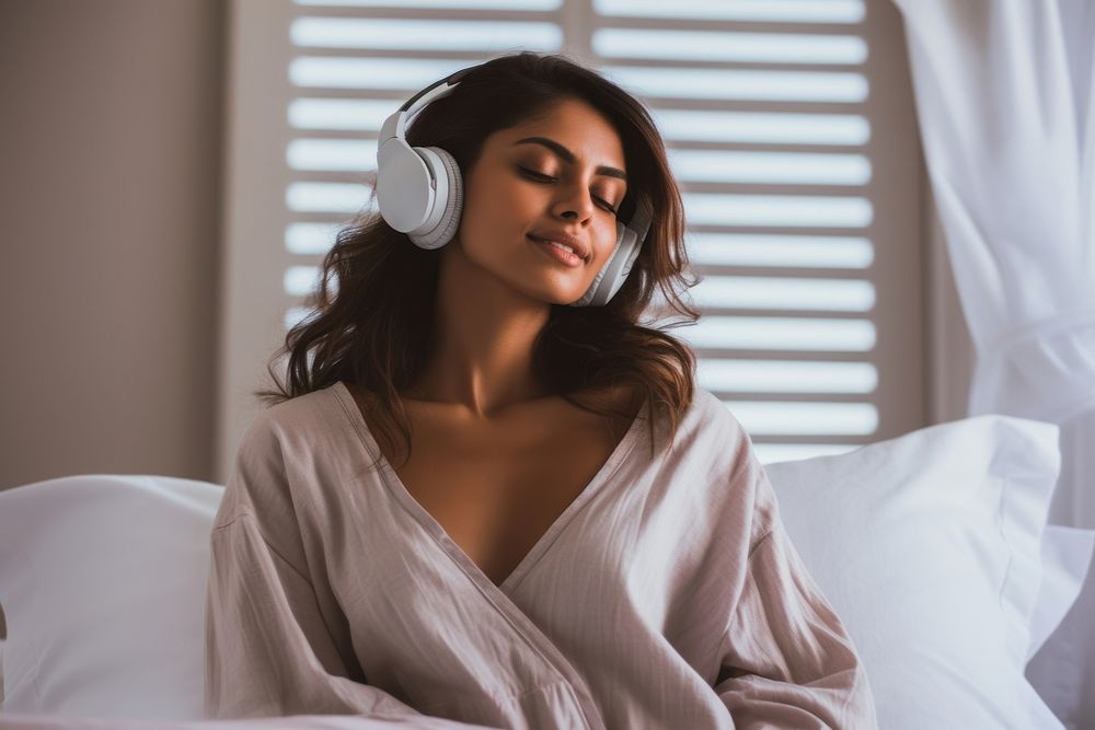 Woman wearing headphones listening bedroom music. AI generated Image by rawpixel.