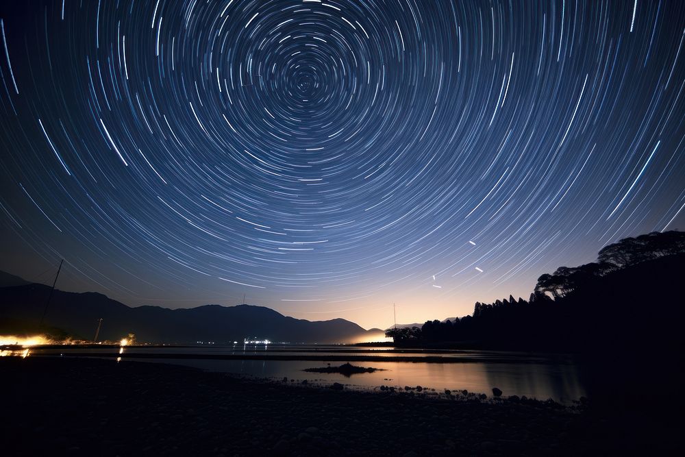 Star trail landscape astronomy outdoors. AI generated Image by rawpixel.