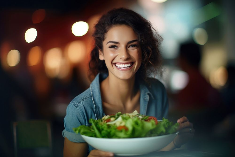 Woman eating a dish of salad adult smile happy. AI generated Image by rawpixel.