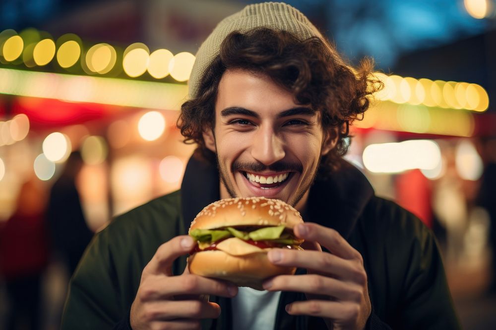 A man eating burger biting adult happy. AI generated Image by rawpixel.