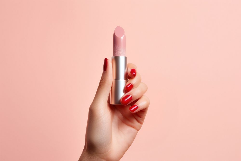 Lipstick cosmetics holding hand. 