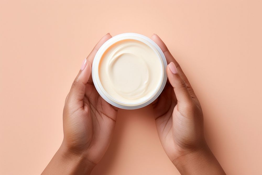 Hand holding moisturizer container finger cup mug. AI generated Image by rawpixel.