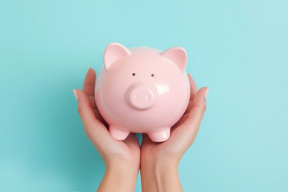 Hand holding piggy bank blue blue background representation. AI generated Image by rawpixel.