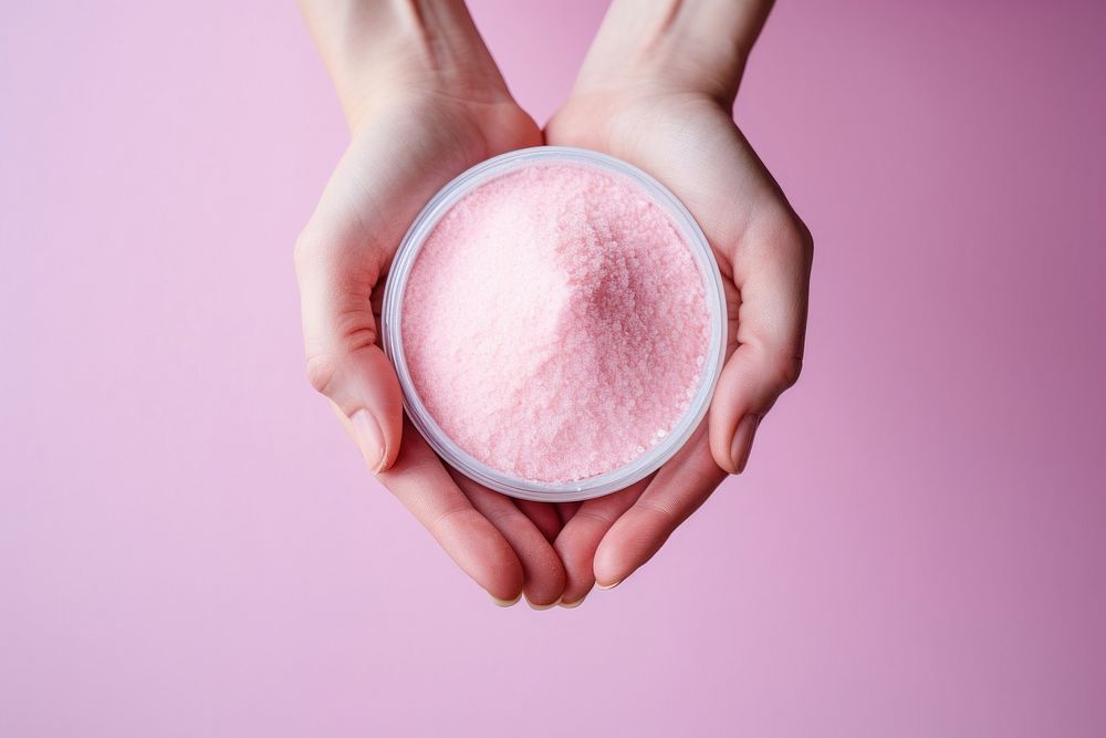 Hand holding pink Powder container powder freshness cosmetics. AI generated Image by rawpixel.