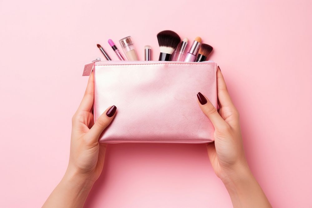 Hands holding cosmetic bag with cosmetic tool cosmetics lipstick brush. AI generated Image by rawpixel.