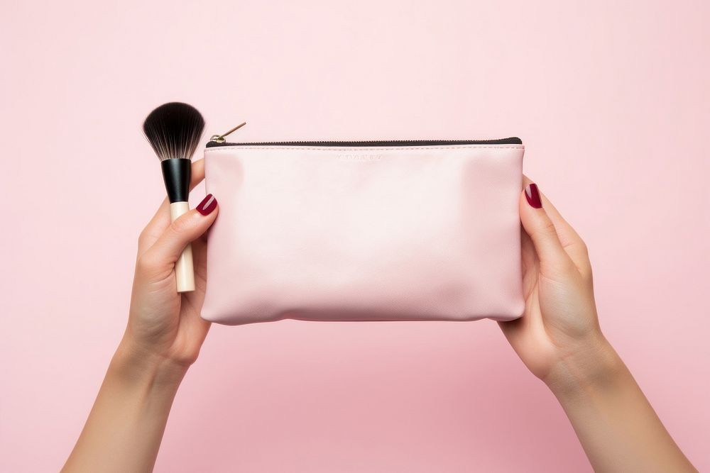Hands holding cosmetic bag with cosmetic tool cosmetics brush pink. AI generated Image by rawpixel.