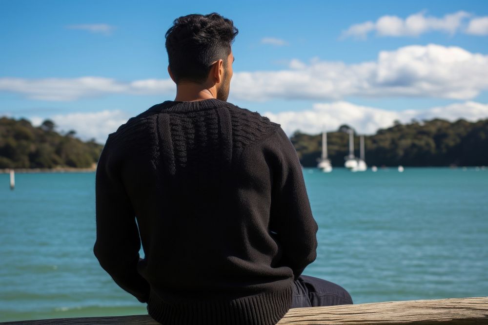 Man with black sweater outdoors sitting nature. AI generated Image by rawpixel.