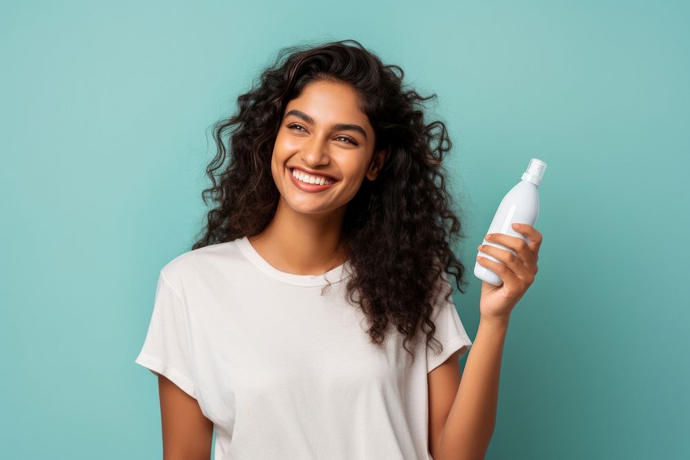 North indian woman bottle smiling holding. AI generated Image by rawpixel.