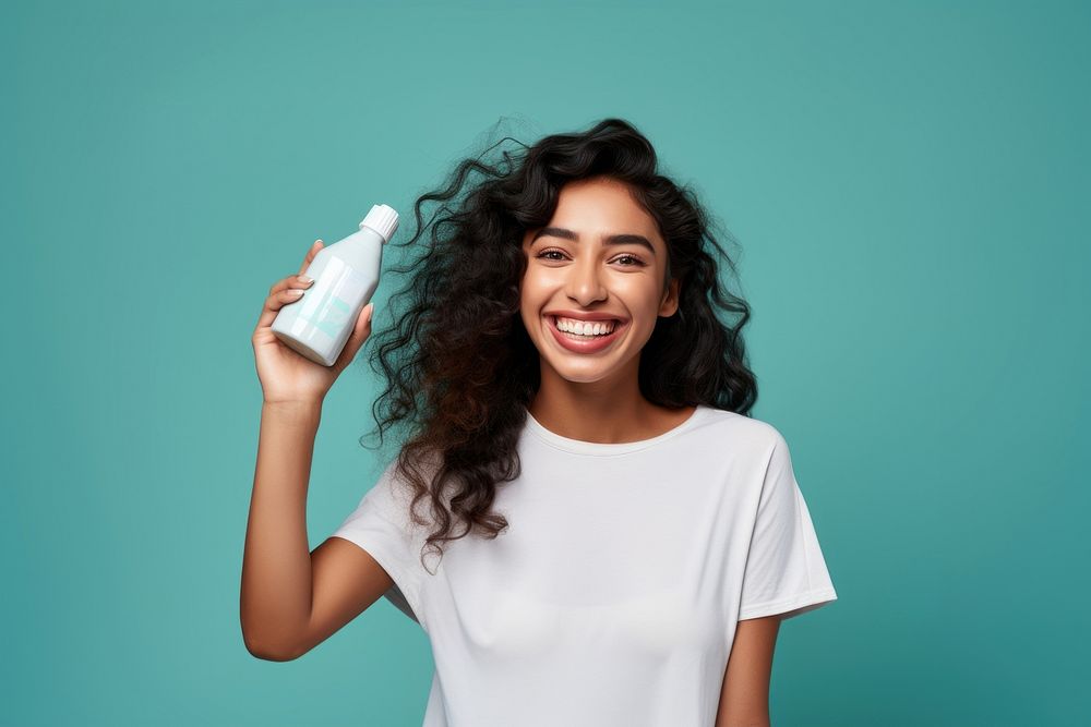 North indian woman smiling holding bottle. AI generated Image by rawpixel.