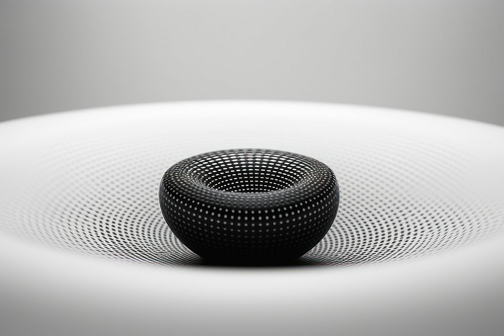 A black and white photo of a circular object electronics simplicity technology. AI generated Image by rawpixel.