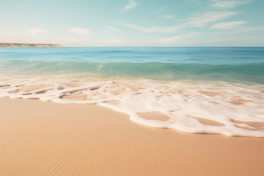 A sandy beach with a wave coming in to shore outdoors horizon nature. AI generated Image by rawpixel.