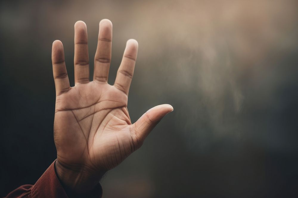 Persons hand raising up finger gesturing touching. 