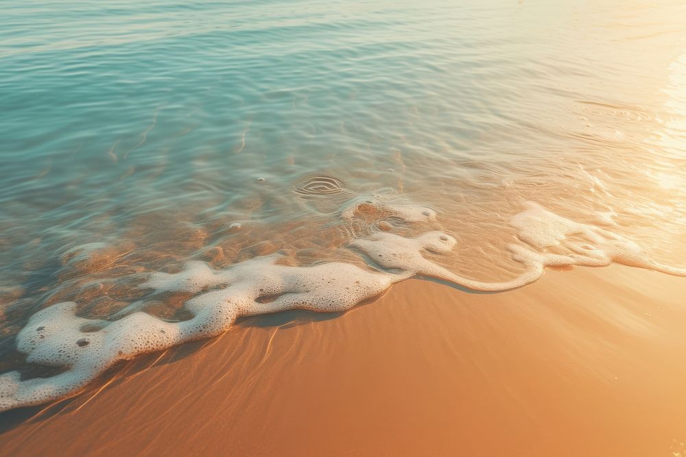 The water is reflecting the sunlight on the sand outdoors nature beach. AI generated Image by rawpixel.