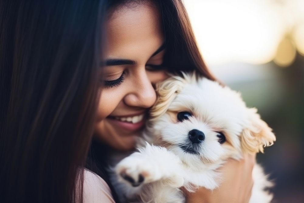 Hispanic young woman playing with a puppy photography portrait mammal. AI generated Image by rawpixel.