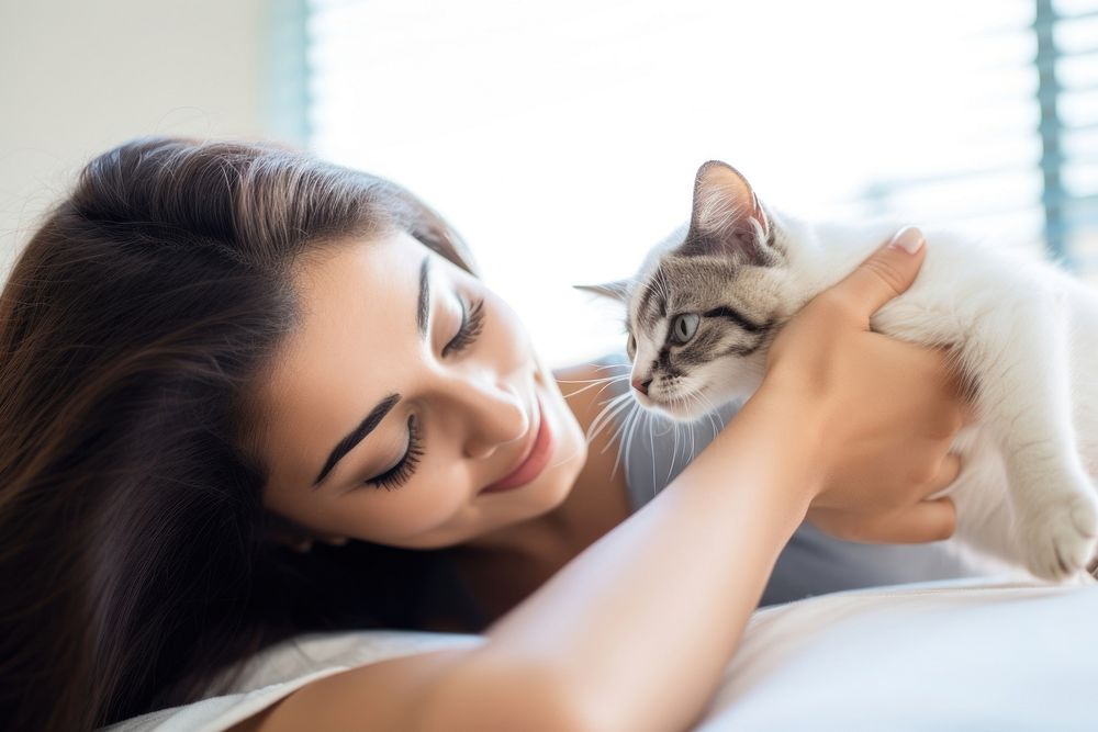Hispanic young woman playing with a kitty animal mammal kitten. AI generated Image by rawpixel.
