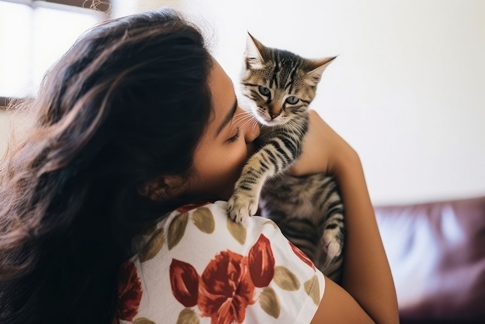 Latinx young woman playing with a kitty animal mammal kitten. AI generated Image by rawpixel.