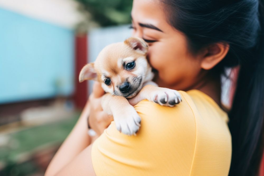 Latinx young woman playing with a puppy photography animal mammal. AI generated Image by rawpixel.