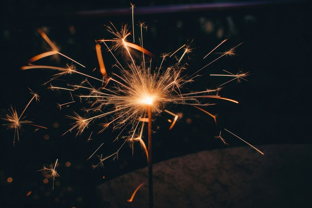 4th of July sparkler fireworks outdoors sparks illuminated. AI generated Image by rawpixel.