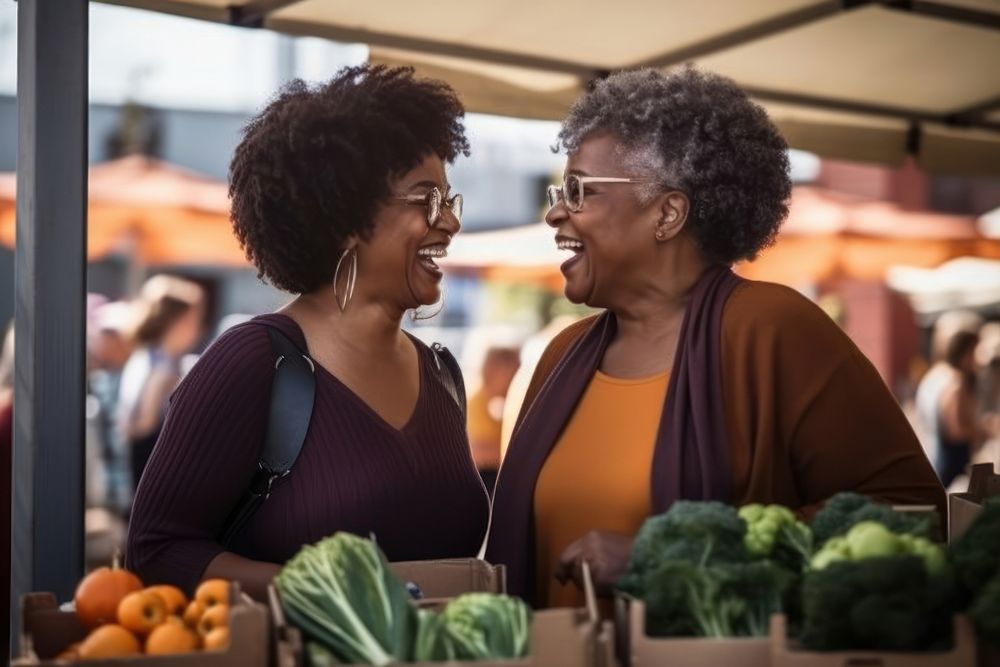 Two black mature women shopping together at an outdoor food market adult togetherness consumerism. AI generated Image by…