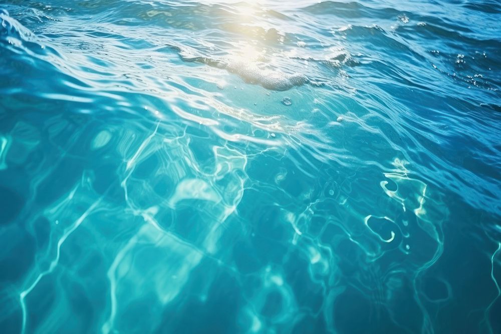 Turquoise ocean water with splashes underwater swimming outdoors. AI generated Image by rawpixel.