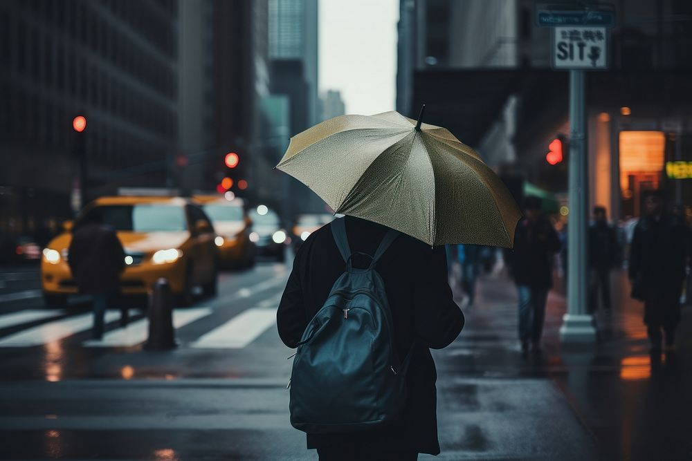 A person with a backpack and an umbrella at New York rain car infrastructure. AI generated Image by rawpixel.