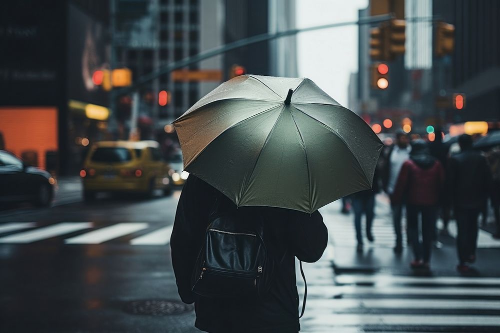 A person with a backpack and an umbrella at New York adult rain car. AI generated Image by rawpixel.