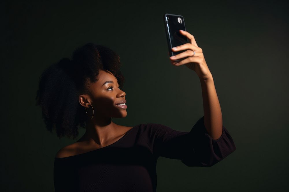 Black Woman taking a selfie with smartphone portrait adult photo. AI generated Image by rawpixel.