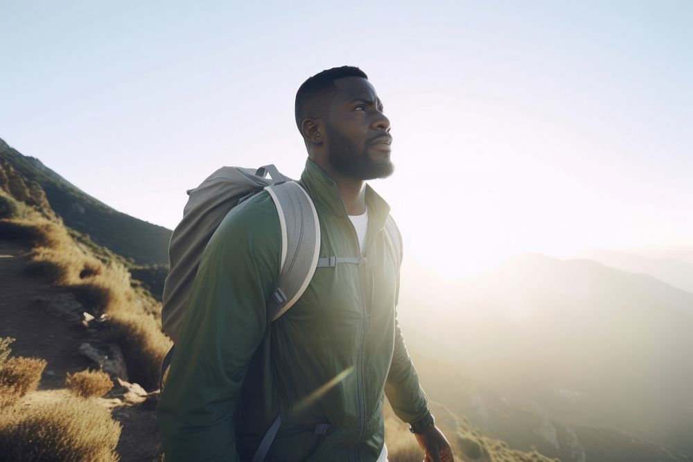 Black Man on early morning hike up mountainside adventure backpack outdoors. AI generated Image by rawpixel.