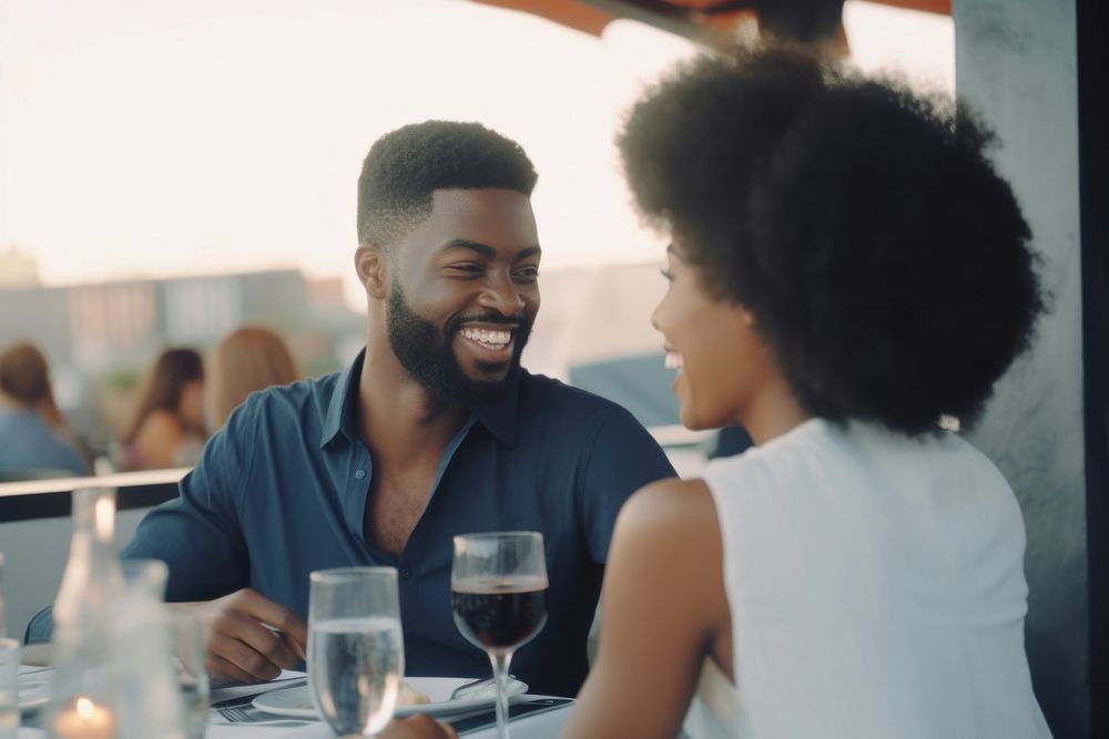 Black smiling couple dining at rooftop restaurant adult togetherness refreshment. AI generated Image by rawpixel.