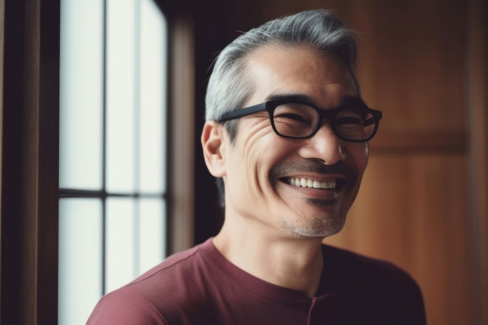 Happy Japanese senior man at home laughing glasses adult. AI generated Image by rawpixel.