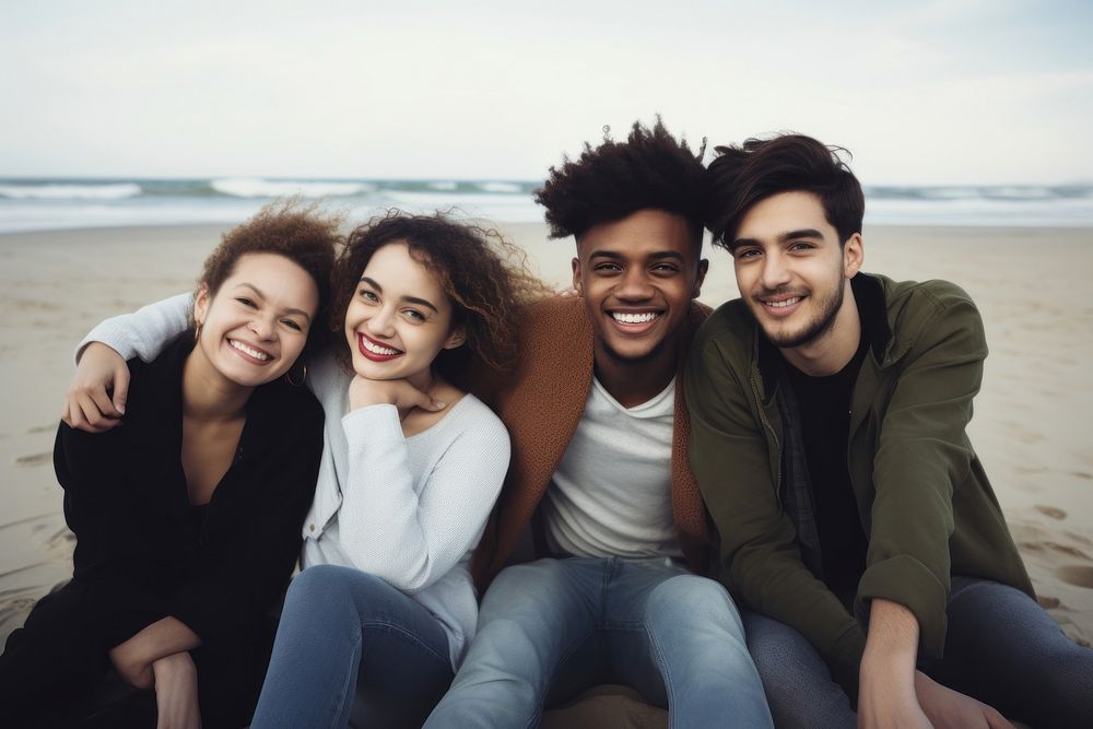 Happy multiracial friends sit leaning on each other at beach laughing portrait outdoors. AI generated Image by rawpixel.