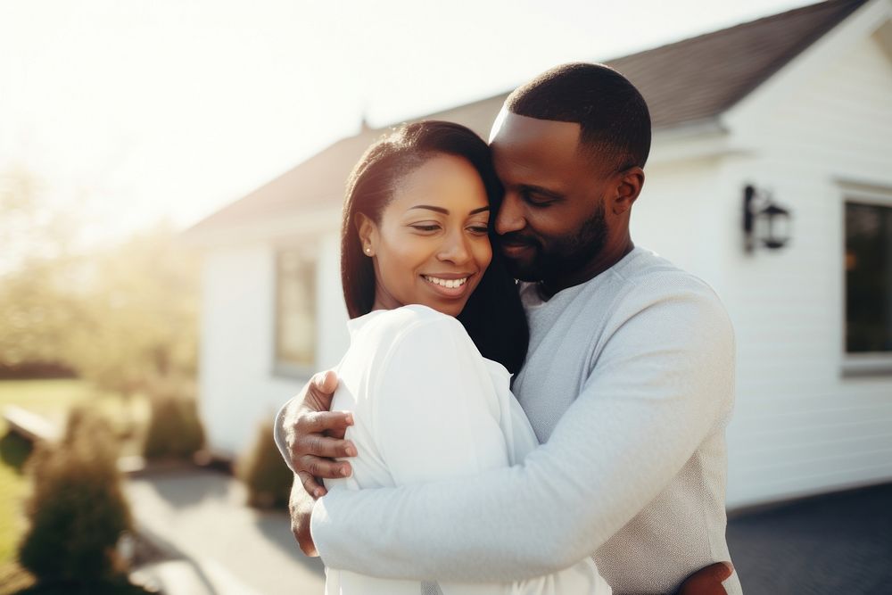 Husband and wife embracing in front of home portrait hugging adult. AI generated Image by rawpixel.