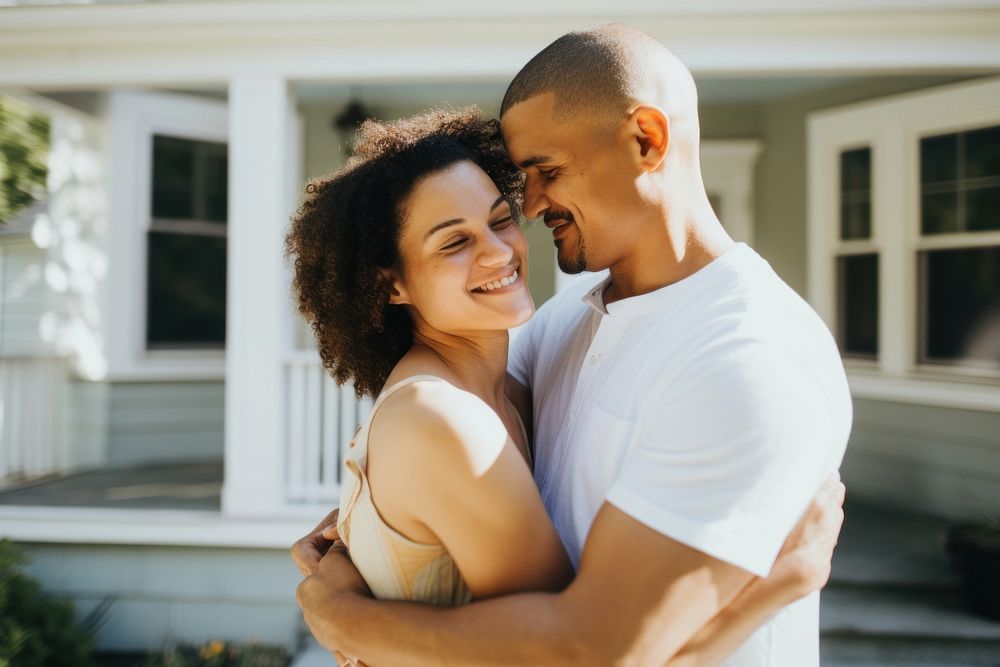 Husband and wife embracing in front of home portrait hugging adult. AI generated Image by rawpixel.