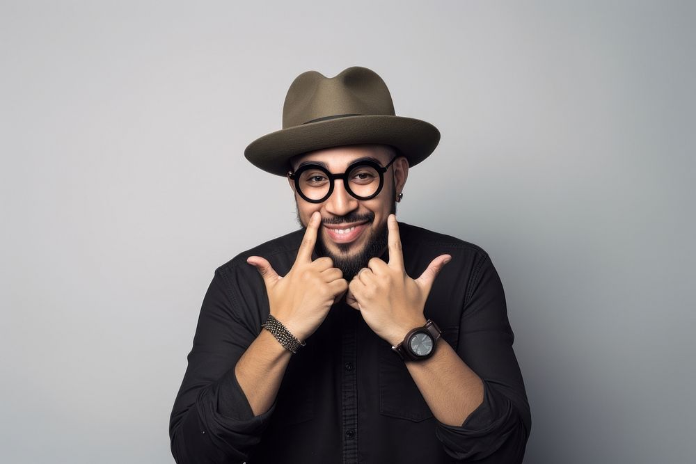 Latinx American man in a hat making a heart with his hands photography portrait adult. AI generated Image by rawpixel.