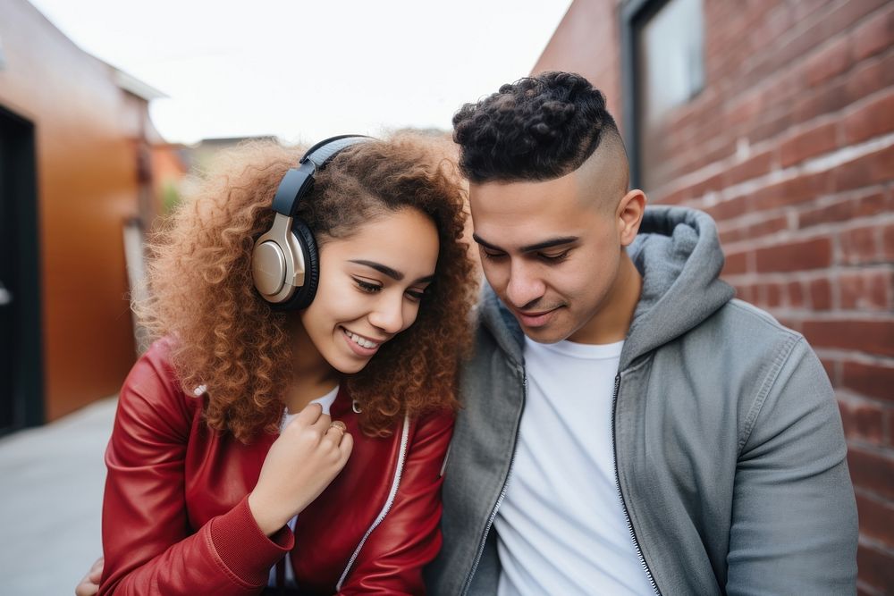 Latinx Young couple listening to music headphones adult togetherness. AI generated Image by rawpixel.