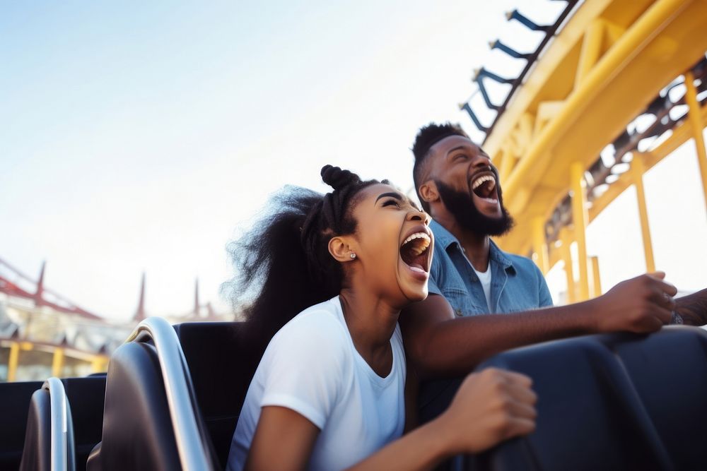 Laughing and screaming black couple riding roller coaster at amusement park travel adult togetherness. AI generated Image by…